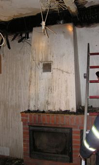 Obrázek 9 – Další příklad špatně provedené teplovzdušné komory, výdechu teplého vzduchu z komory s absencí izolační komory a neizolovaných teplovzdušných rozvodů. Výsledkem je požár dřevěného stropu budovy.