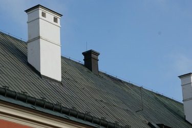 Obr. 3 Malý komín kotelny v horní části u hřebene střechy a níže na střeše větrací průduchy. Vnější vzhled musel být zachován.